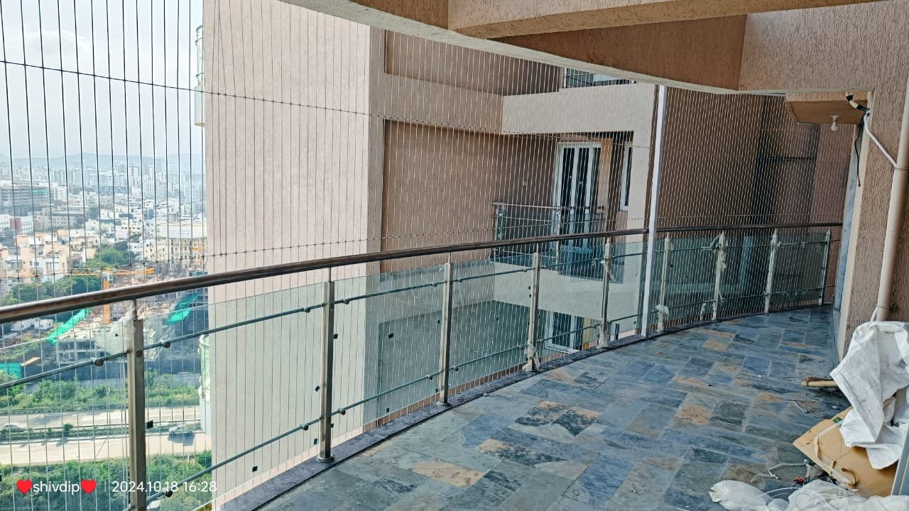 Modern apartment balcony with invisible grill in Pune